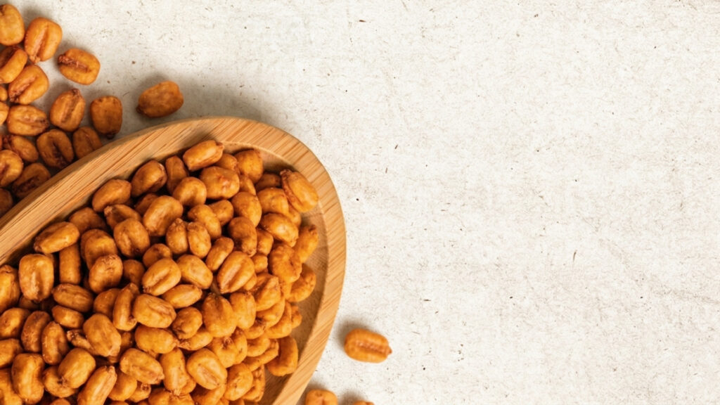 Bulk production of flavored corn snacks in a modern factory setting.
