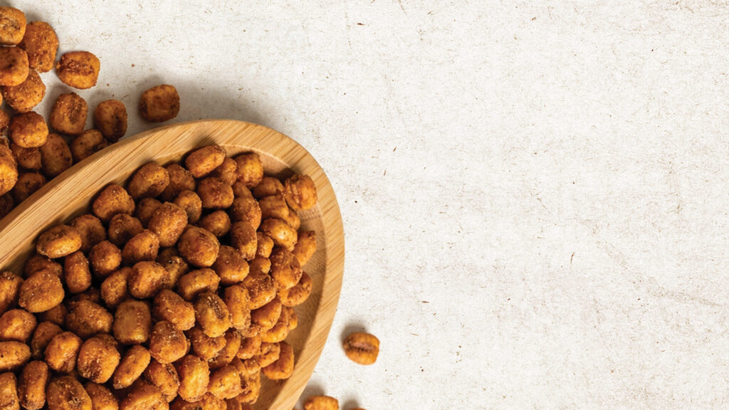 Bulk production of flavored corn snacks in a modern factory setting.
